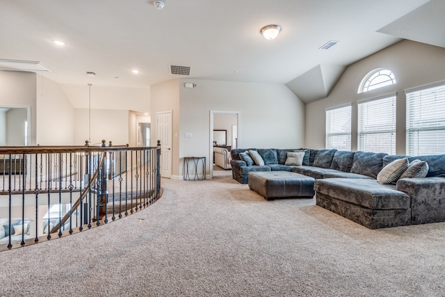 carpeted living room with a notable chandelier and vaulted ceiling