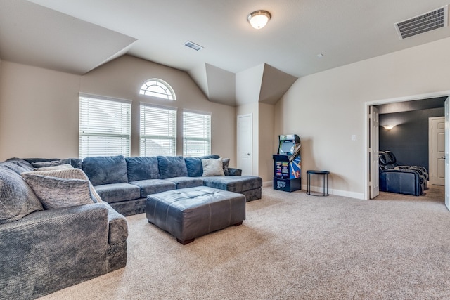 carpeted living room featuring lofted ceiling