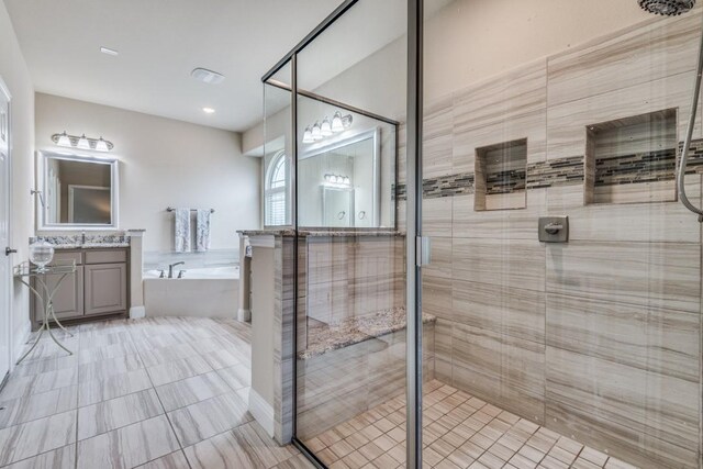 bathroom with vanity, independent shower and bath, and tile patterned floors