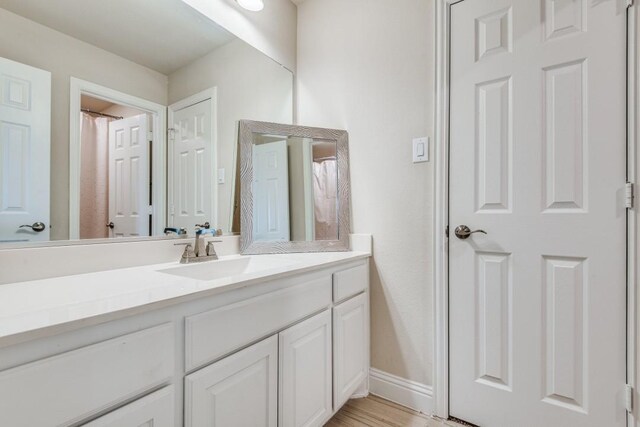 bathroom with vanity and hardwood / wood-style floors