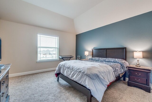 bedroom with light carpet and vaulted ceiling