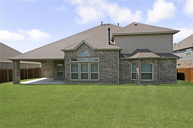 back of property featuring a lawn and a patio area