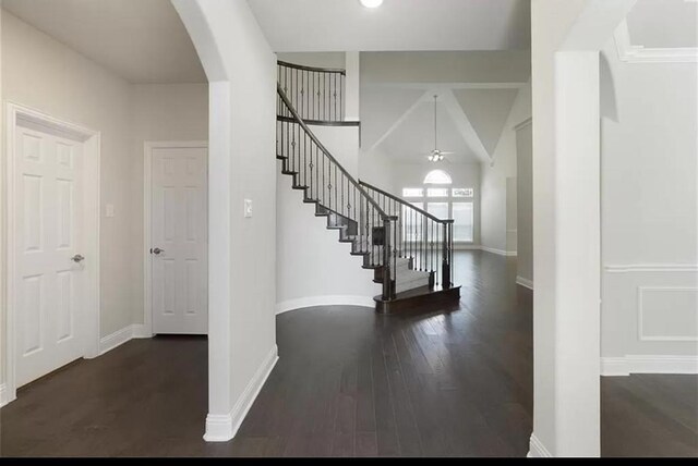 staircase featuring lofted ceiling and wood-type flooring