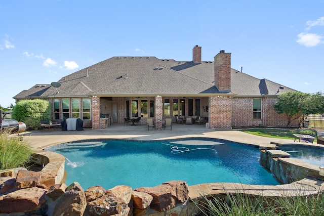 view of swimming pool with a patio and pool water feature