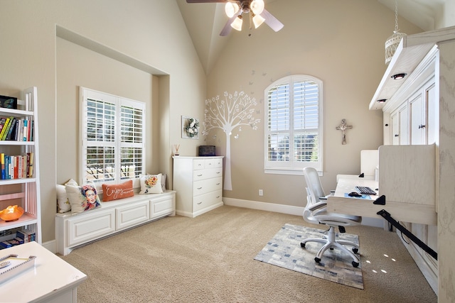 carpeted home office featuring ceiling fan and high vaulted ceiling