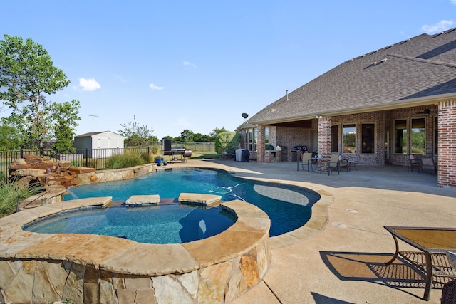 view of swimming pool featuring a patio area and an in ground hot tub