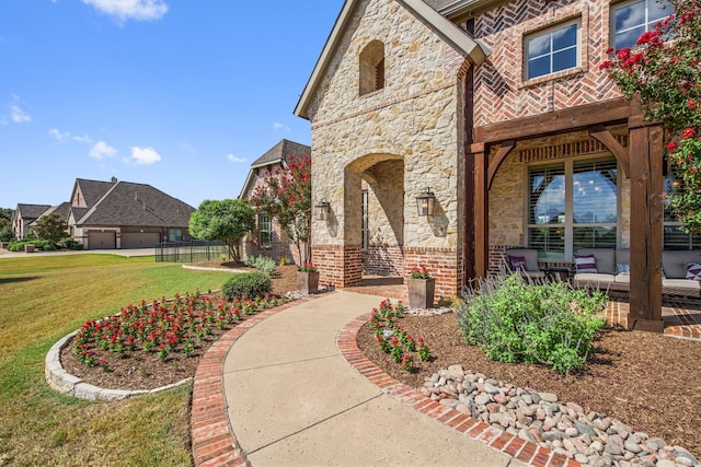 doorway to property featuring a patio area and a yard