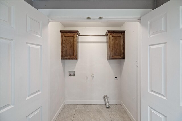 clothes washing area with hookup for a washing machine, cabinets, gas dryer hookup, hookup for an electric dryer, and light tile patterned flooring