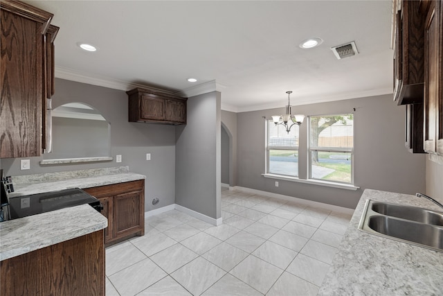 kitchen featuring a notable chandelier, light tile patterned floors, ornamental molding, sink, and dark brown cabinetry