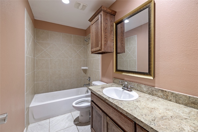 full bathroom featuring tile patterned flooring, vanity, toilet, and tiled shower / bath