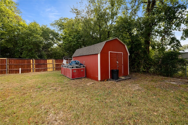 view of outbuilding featuring a lawn