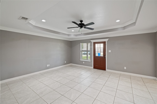 tiled spare room with ceiling fan, a raised ceiling, and crown molding