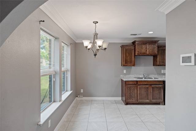 kitchen with pendant lighting, a notable chandelier, light tile patterned floors, crown molding, and sink