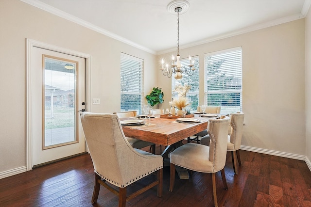 dining room featuring dark wood-type flooring, a notable chandelier, and crown molding