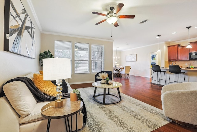 living room featuring ornamental molding, dark hardwood / wood-style flooring, and ceiling fan