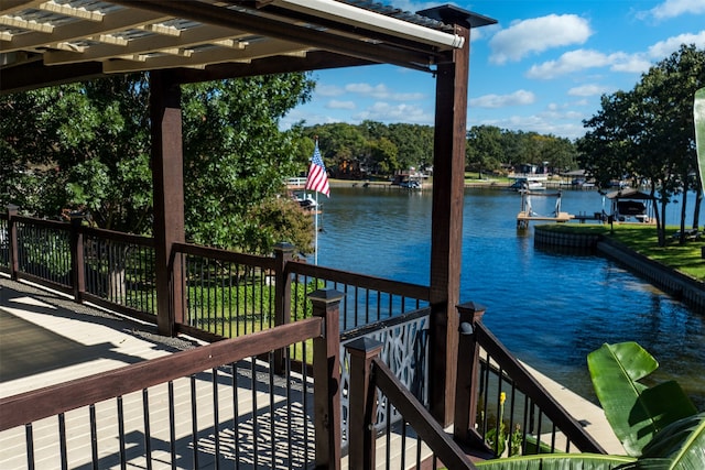 view of dock with a pergola and a water view