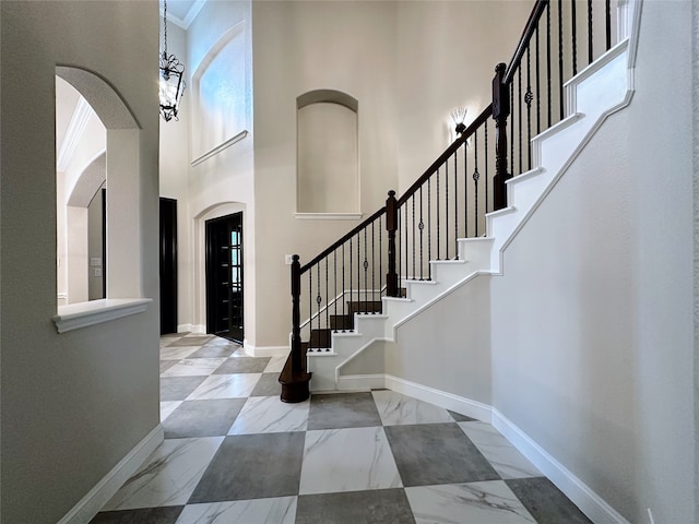 entryway featuring a towering ceiling