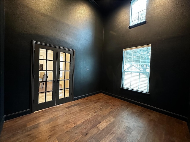 1424 Palestine Dr, Prosper, TX 75078 - spare room featuring a textured wall, french doors, plenty of natural light, and wood finished floors