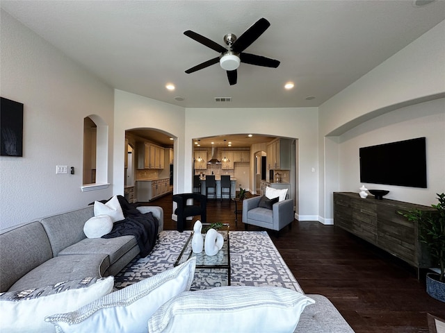 1424 Palestine Dr, Prosper, TX 75078 - living room featuring dark wood finished floors, visible vents, a ceiling fan, and arched walkways