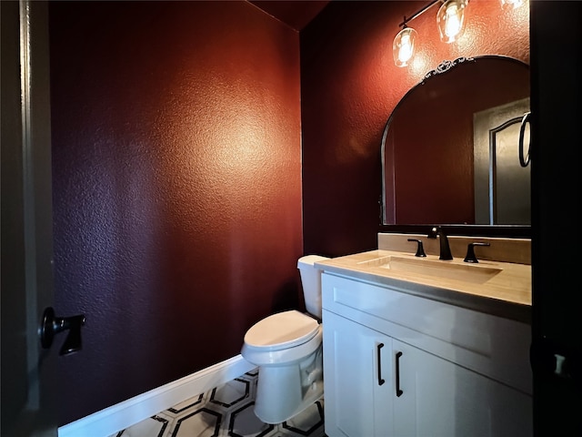 bathroom with vanity and toilet