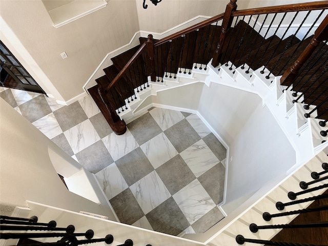 stairway featuring tile patterned flooring