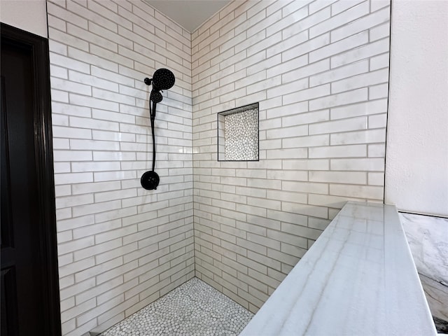 bathroom with a tile shower