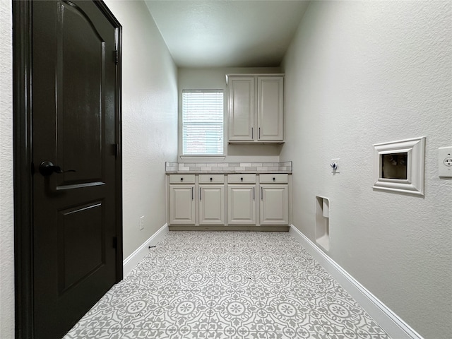 laundry room featuring cabinets and hookup for an electric dryer