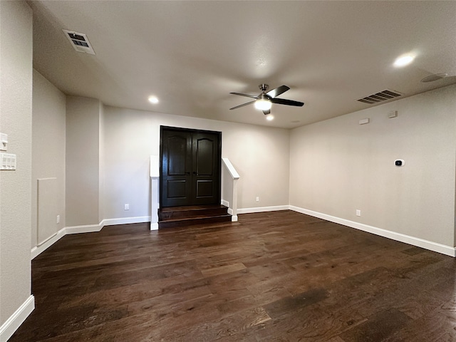 unfurnished room with dark hardwood / wood-style flooring and ceiling fan