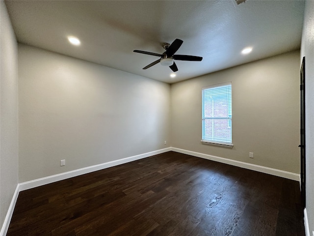 spare room with ceiling fan and dark hardwood / wood-style flooring