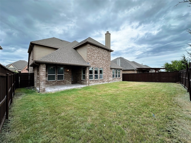 back of property featuring a lawn and a patio