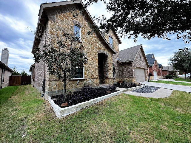 1424 Palestine Dr, Prosper, TX 75078 - view of front facade with stone siding, a garage, fence, concrete driveway, and a front yard