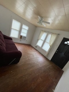 additional living space featuring hardwood / wood-style flooring, a wealth of natural light, cooling unit, and ceiling fan