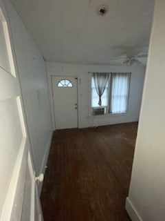 doorway with dark wood-type flooring, cooling unit, and ceiling fan