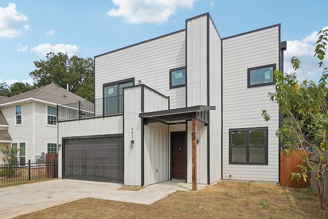 contemporary house with a garage and a front lawn