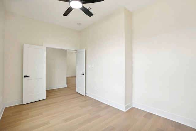 unfurnished bedroom with light hardwood / wood-style flooring, a closet, and ceiling fan