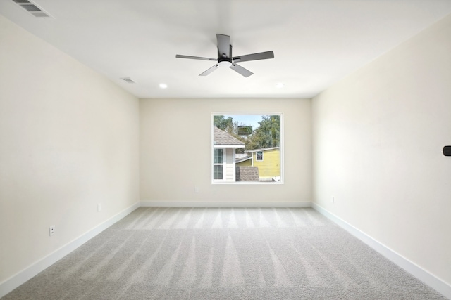 unfurnished room featuring ceiling fan and light colored carpet