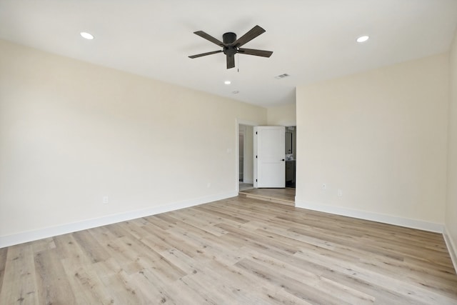 spare room featuring light wood-type flooring and ceiling fan