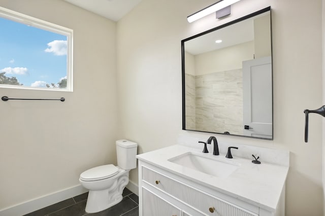 bathroom with vanity, toilet, and tile patterned floors