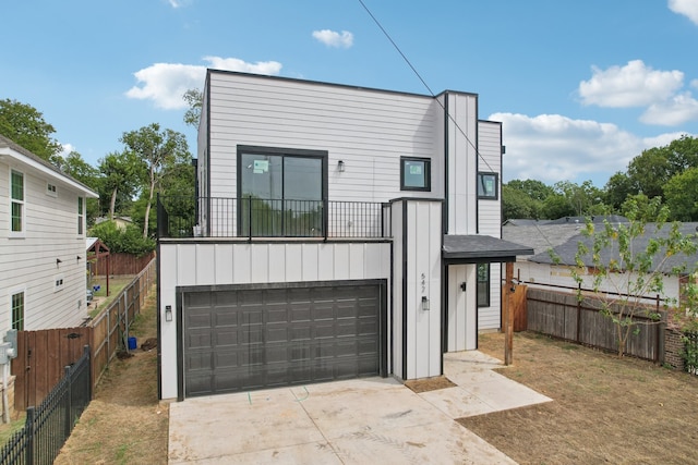 view of front of property with a balcony and a garage