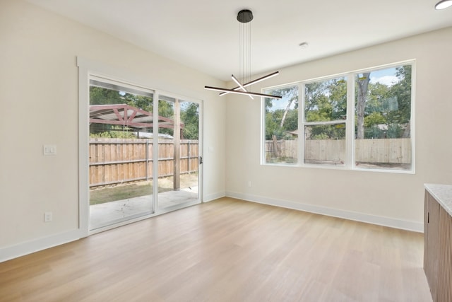 interior space featuring light wood-type flooring and a wealth of natural light