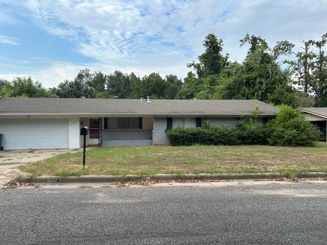 single story home with a garage and a front lawn