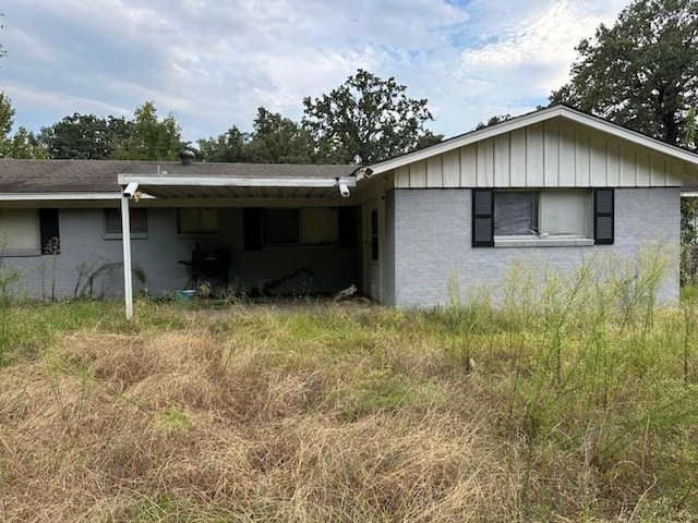 exterior space featuring an attached carport and brick siding