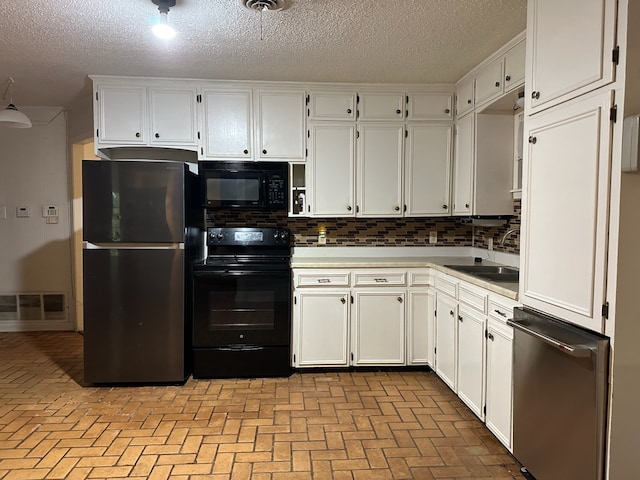 kitchen featuring white cabinetry, a textured ceiling, black appliances, sink, and decorative backsplash