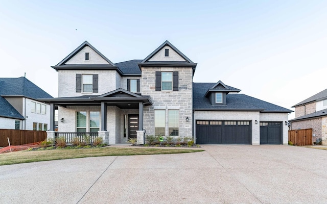 view of front of home featuring a porch and a garage