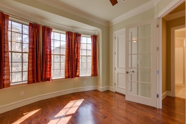 empty room featuring crown molding and wood-type flooring