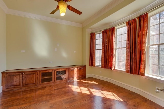 unfurnished room with plenty of natural light, ceiling fan, and wood-type flooring