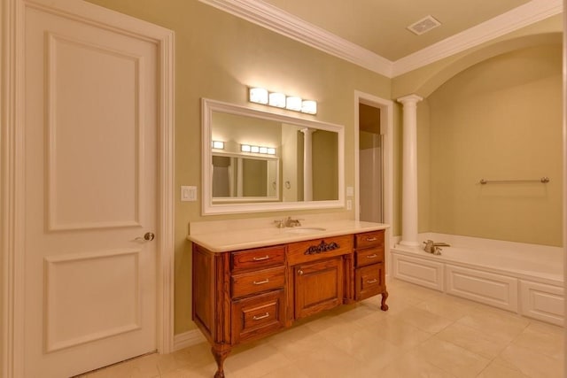 bathroom with tile patterned floors, ornamental molding, vanity, a washtub, and ornate columns