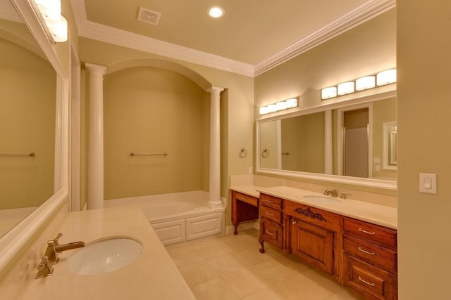 bathroom featuring tile patterned flooring, a bathing tub, ornate columns, ornamental molding, and vanity