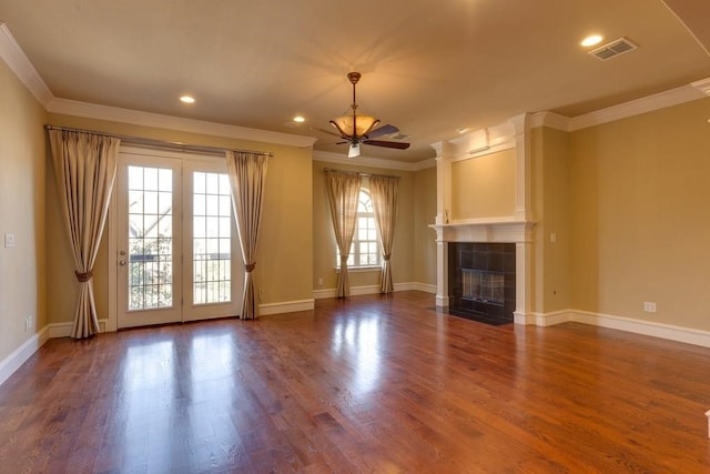 unfurnished living room with a fireplace, a wealth of natural light, wood-type flooring, and ceiling fan