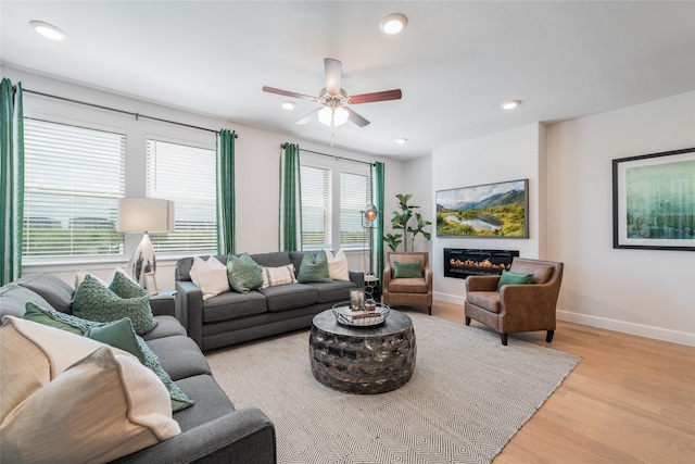 living room featuring ceiling fan and light wood-type flooring